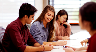 A group of students studying together at a desk.